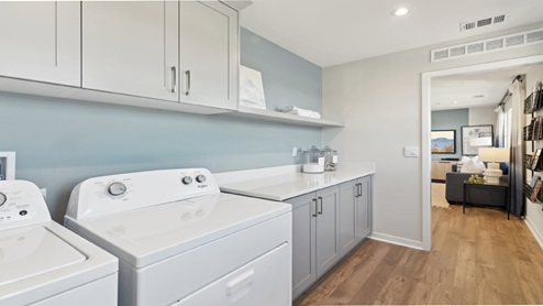 Laundry room with upper and lower cabinets and washer and dryer