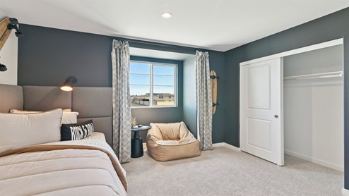Secondary bedroom with twin bed and closet