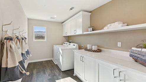 Laundry room with upper and lower cabinets and washer and dryer