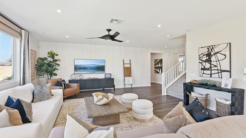 Spacious open-concept great room with open railing stairs
