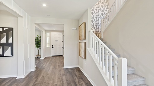 Open railing stairs with white handrail