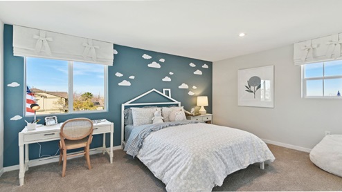 Secondary bedroom with full bed and desk