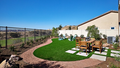 Spacious backyard with patio area and outdoor furniture