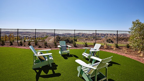 Spacious backyard with patio area and outdoor furniture with view of the mountainside