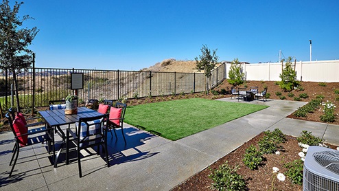 Spacious backyard with lawn and patio area