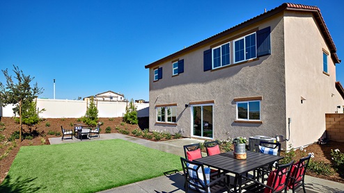 Spacious backyard with lawn and patio area