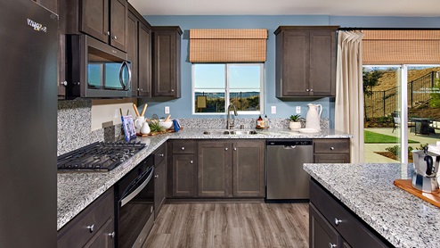 modern open-concept kitchen area with granite countertops