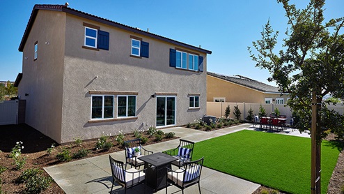 Spacious backyard with lawn and patio area