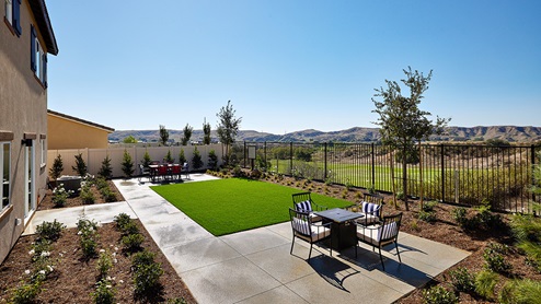 Spacious backyard with lawn and patio area