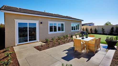 Spacious backyard with patio area and outdoor furniture