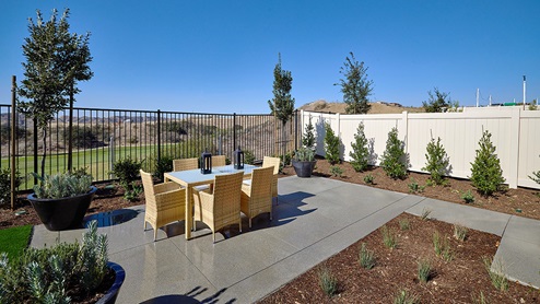 Spacious backyard with patio area and outdoor furniture