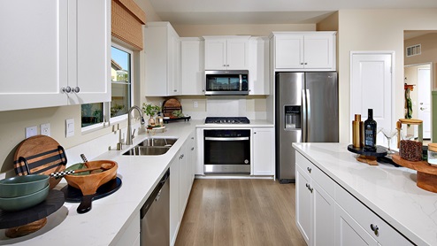 modern open-concept kitchen area with white cabinets