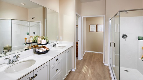 Primary bathroom with walk in shower and double sinks