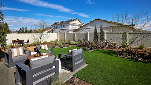 Spacious backyard with patio area and outdoor furniture