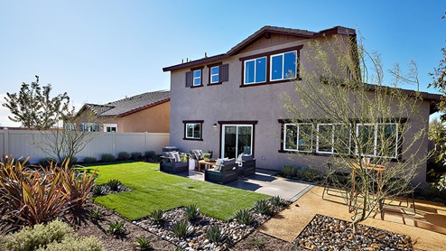 Spacious backyard with patio area and outdoor furniture