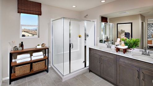 Primary bathroom with his and hers sinks and walk-in shower