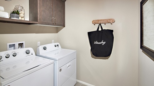 Laundry room with washer and dryer, and upper shelf and cabinet