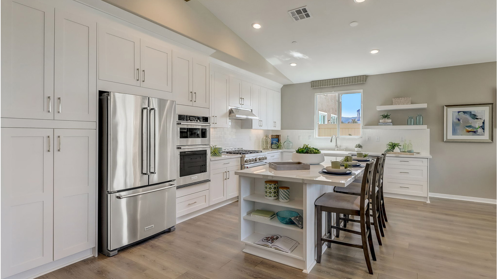 Kitchen with white cabinets quartz countertops and stainless steel appliances