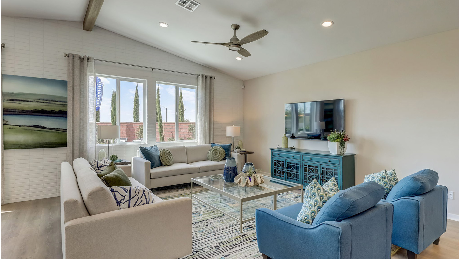 Spacious open-concept great room, dining room and kitchen with vaulted ceiling