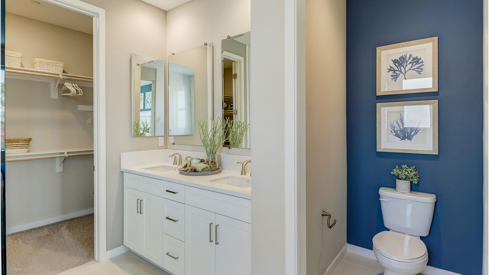 Primary bathroom with dual vanities and walk in closet