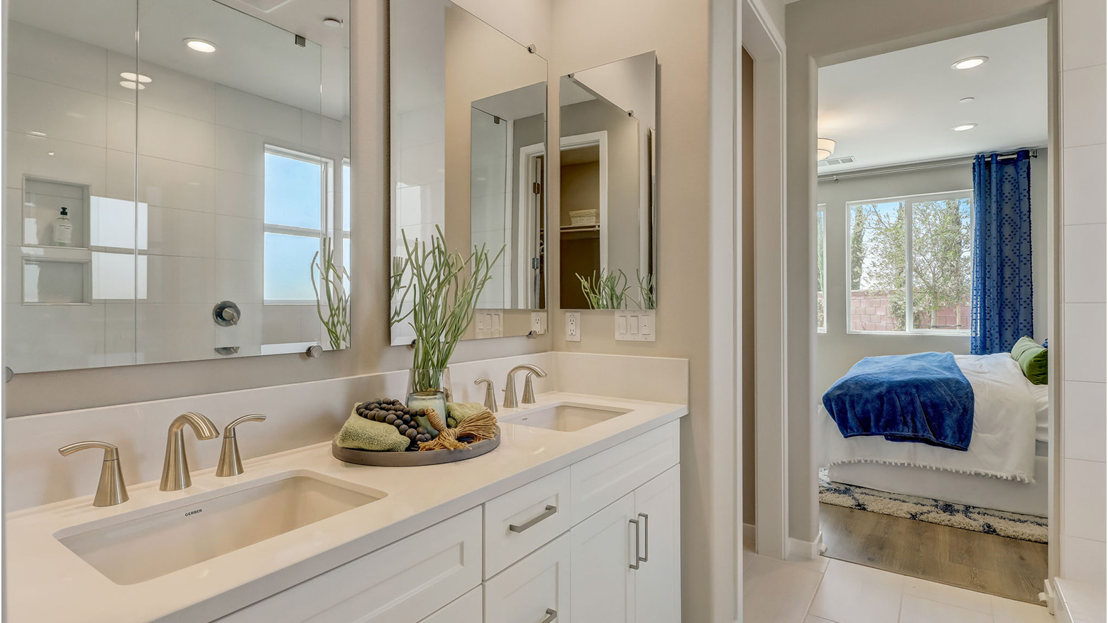 Primary bathroom with dual vanities and walk in shower and separate tub