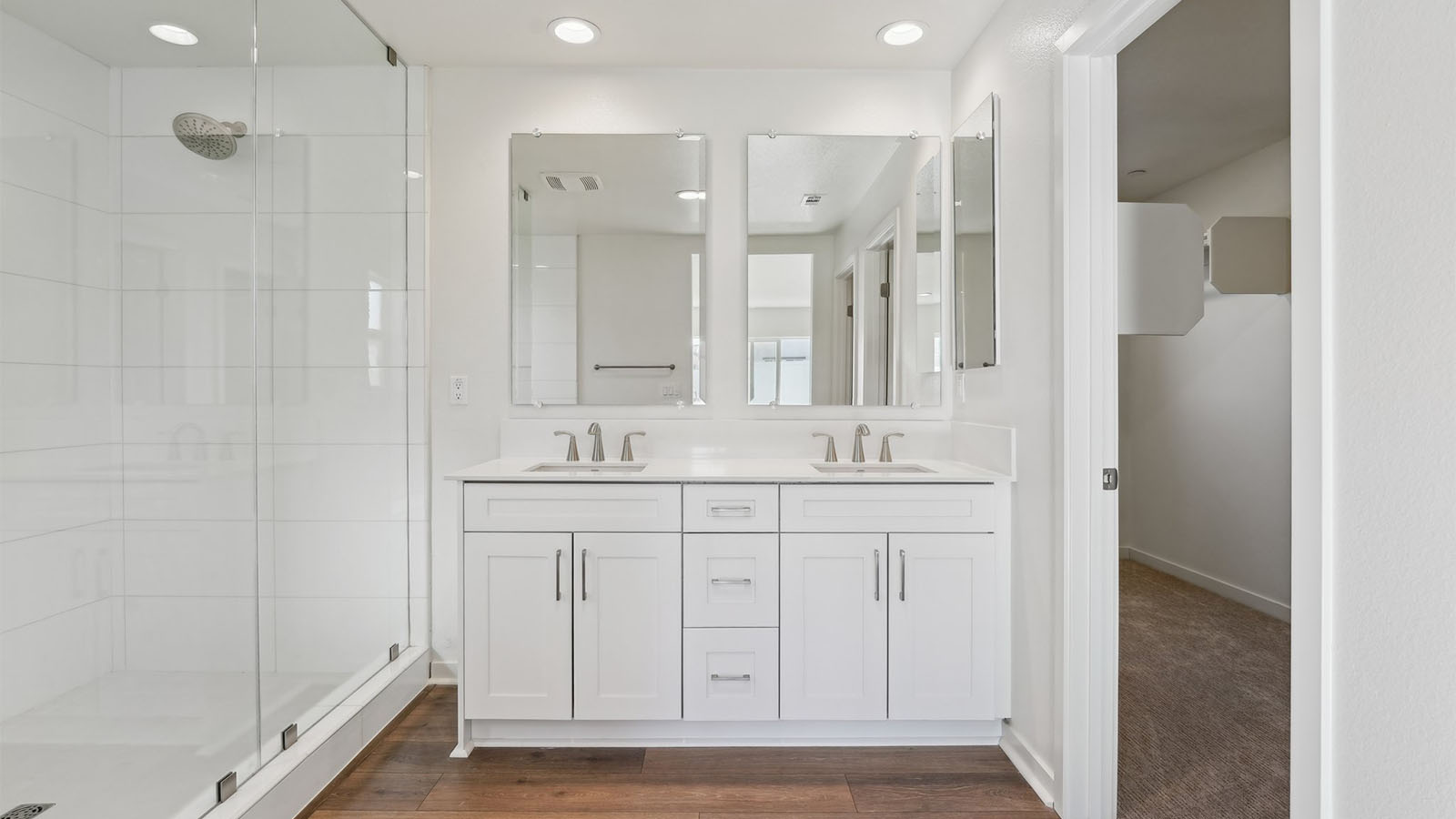 Primary bathroom with dual vaniteis and walk-in shower