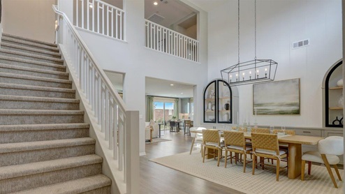 Spacious open-concept dining room and open staircase