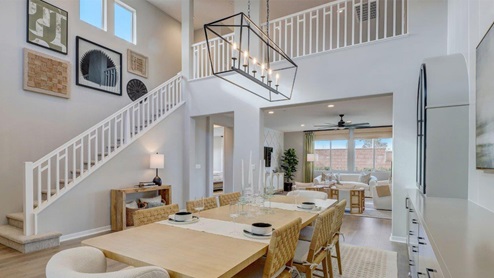 Spacious open-concept dining room with open staircase