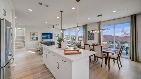 Spacious open-concept kitchen with stainless steel appliances and quartz countertops and dining room