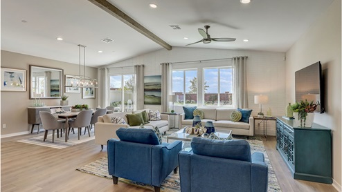 Open-concept great room, kitchen and dining area with vaulted ceiling
