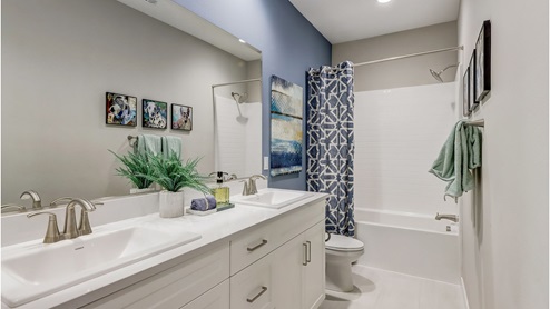 Bathroom with his and hers sinks, shower and tub