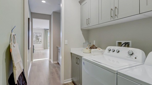 Laundry room with washer and dryer and upper cabinet