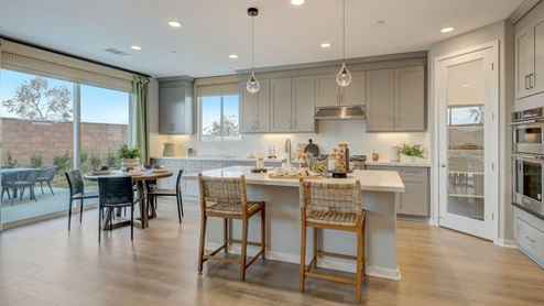 Open-concept kitchen with quartz countertops and stainless steel appliances and dining nook