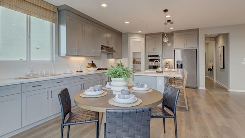 Open-concept kitchen with quartz countertops and stainless steel appliances and dining nook