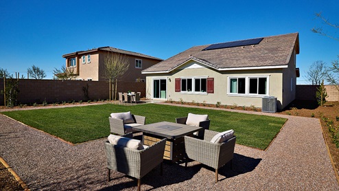 Spacious backyard with patio area and outdoor furniture