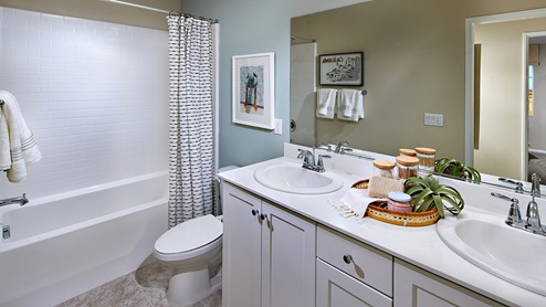 Bathroom with shower and double sinks