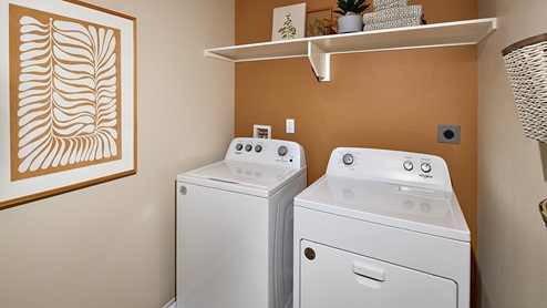 Laundry room with upper shelf