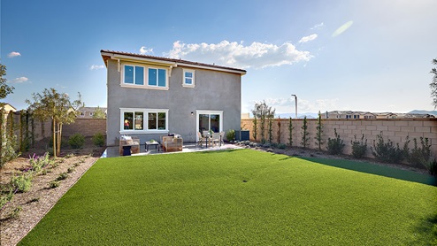 Spacious open-concept backyard with patio area