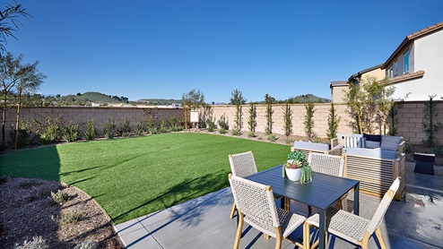 Spacious open-concept backyard with patio area