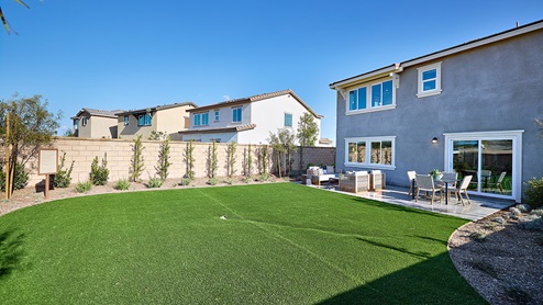 Spacious open-concept backyard with patio area