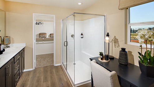 Primary bathroom with walk-in shower and his and hers sinks
