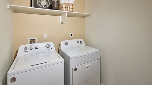 Laundry room with upper shelf