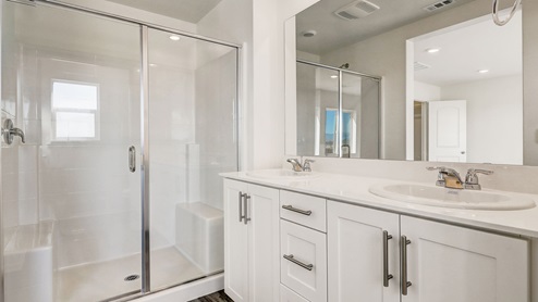 Primary bathroom with shower, his and hers sinks