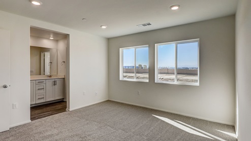 Primary bedroom with plush carpet