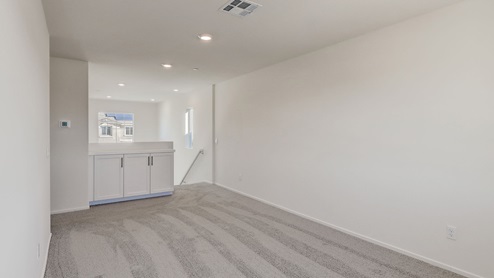 Open-concept loft area with plush carpet
