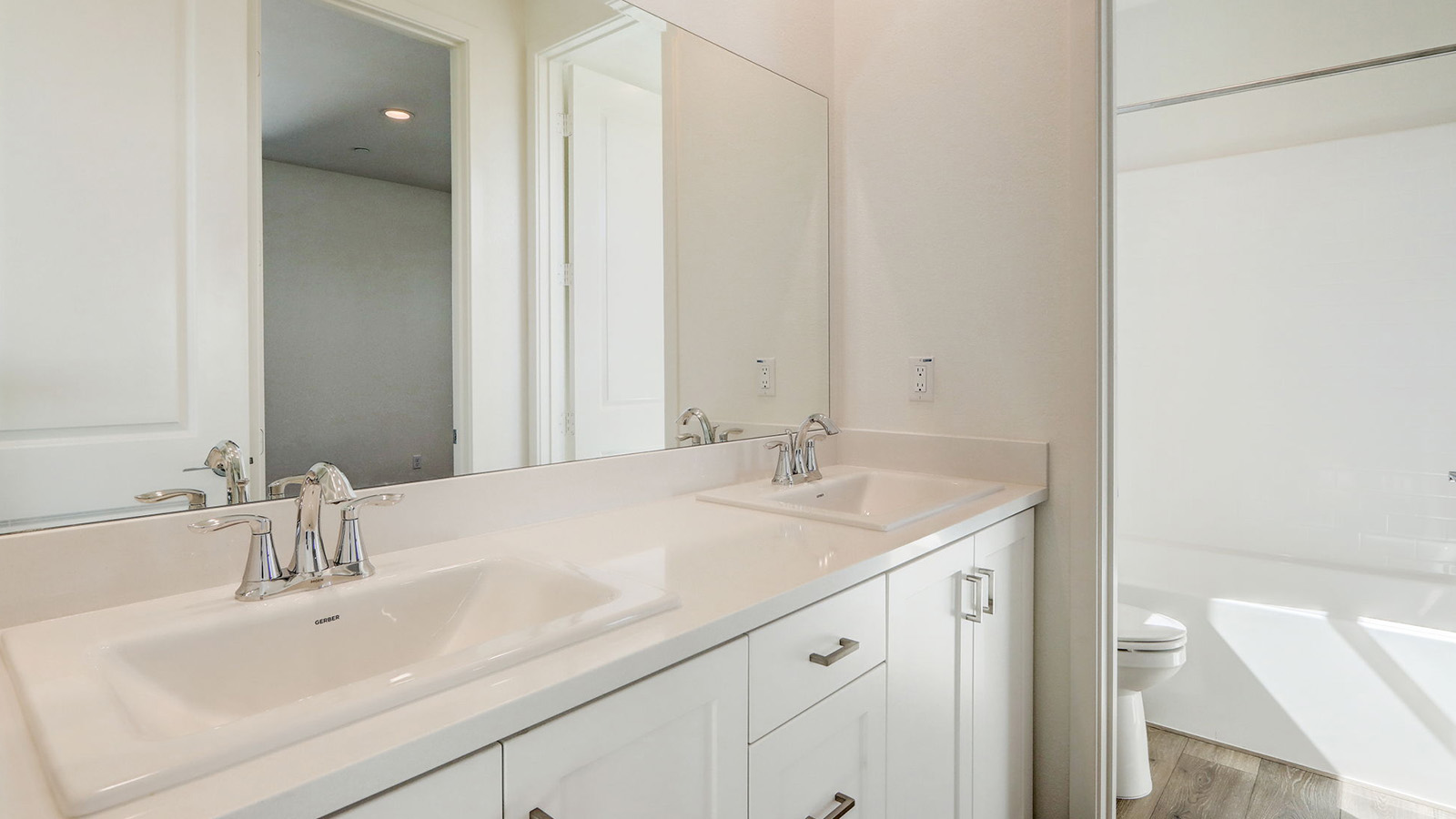 Secondary bathroom with vanity and tub shower combination