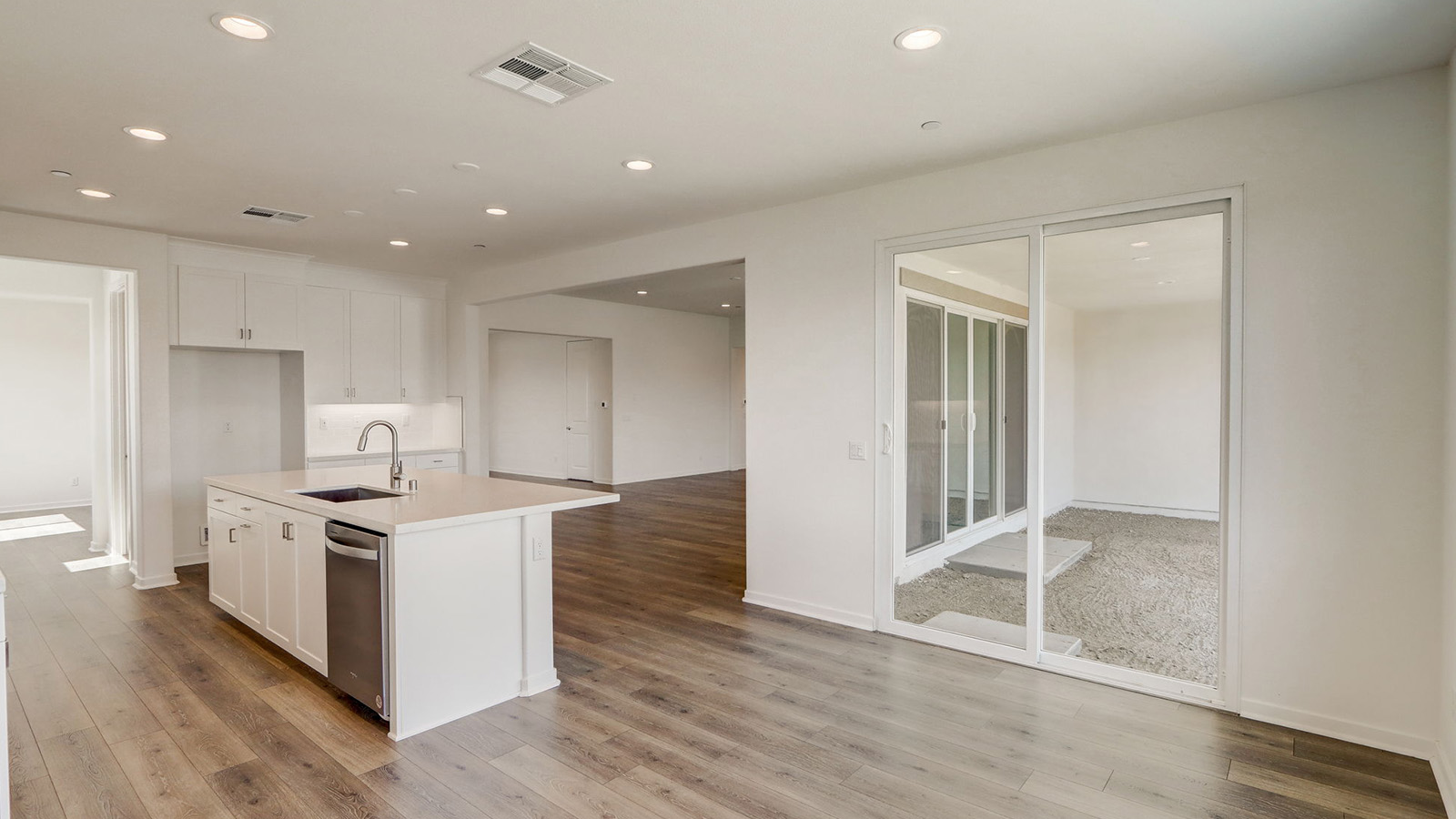 Kitchen with white cabinets quartz countertops and stainless steel appliances