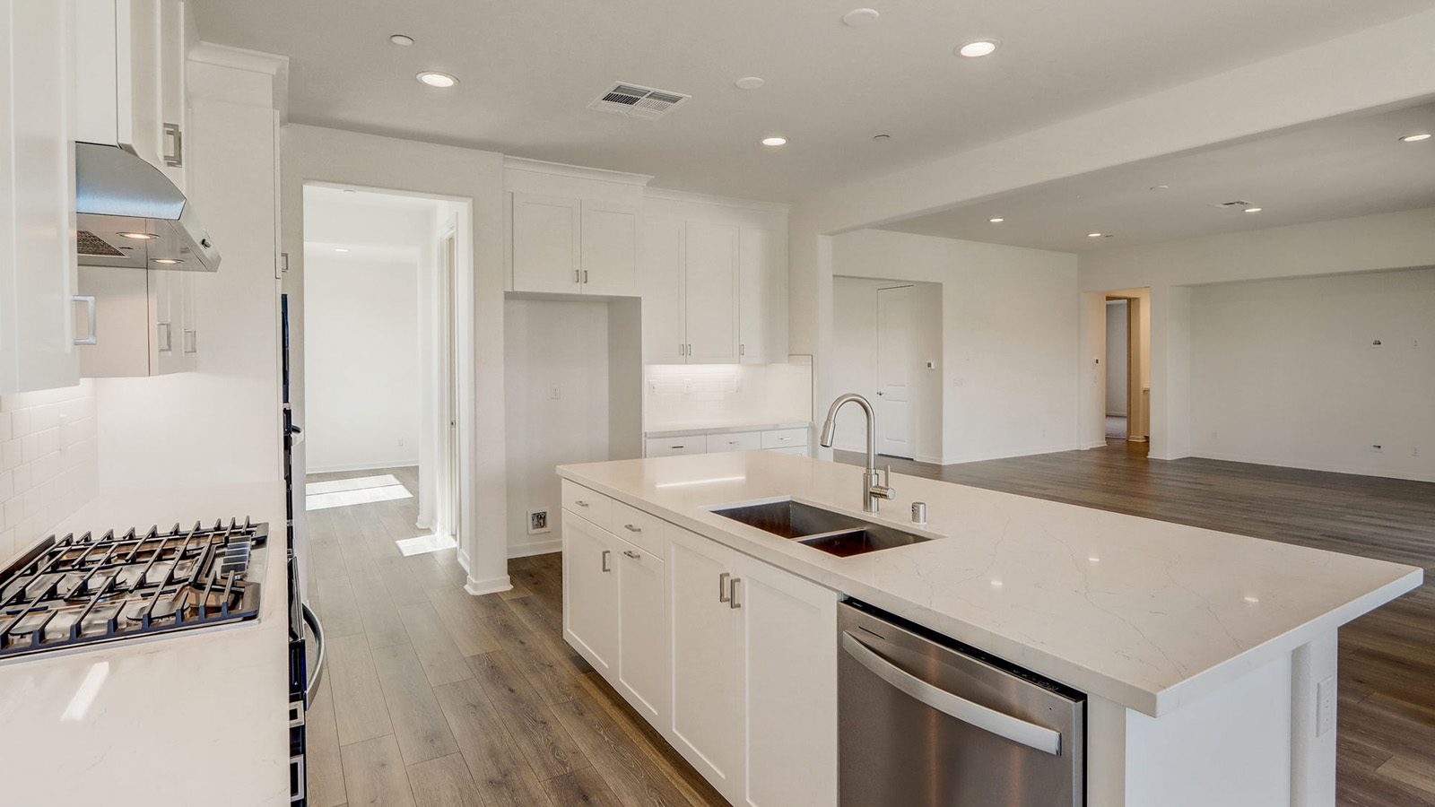 Kitchen with white cabinets quartz countertops and stainless steel appliances