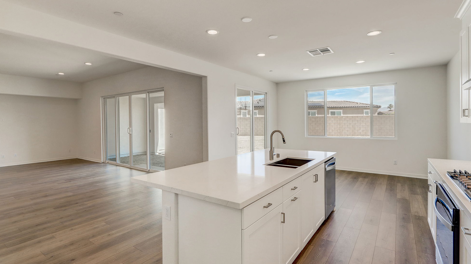 Kitchen with white cabinets quartz countertops and stainless steel appliances
