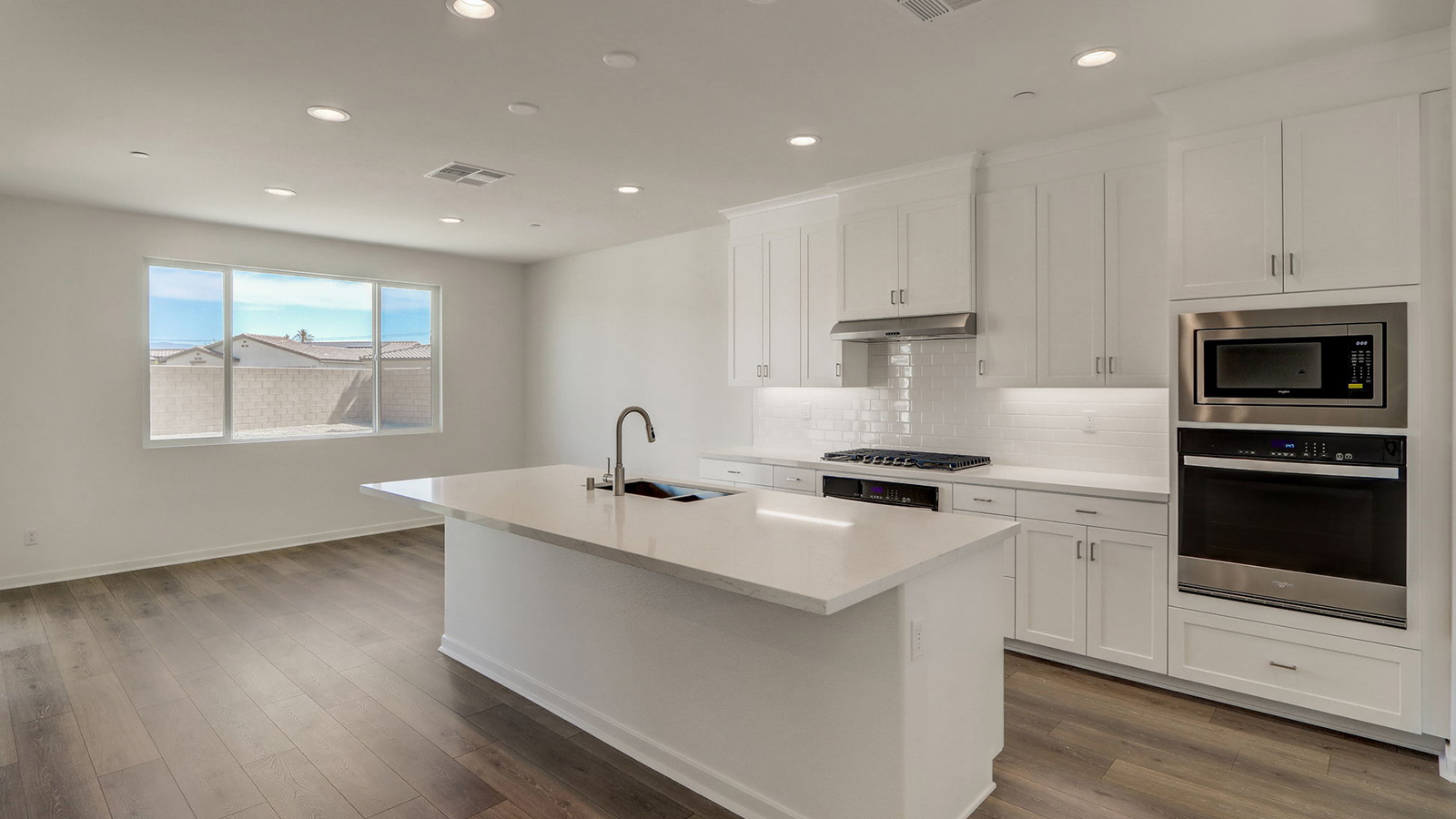 kitchen with white cabinets quartz countertops and stainless steel appliances